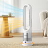 Devanti 2-In-1 Bladeless Tower Fan Heater In White And Silver Standing In A Modern Bedroom