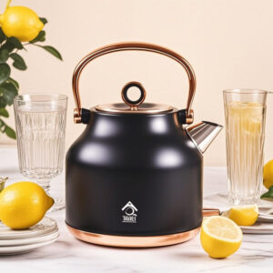 Matte black electric water kettle with gold handle standing on a kitchen bench