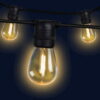 59m outdoor LED festoon string lights casting a warm white glow across an expansive backyard wedding venue