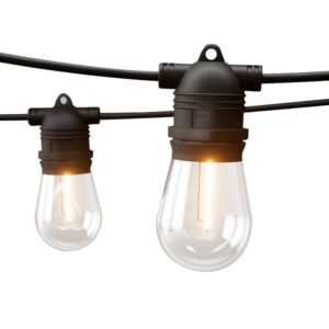 82m outdoor festoon lights zigzagging over a backyard patio dining set at twilight
