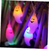 Illuminated LED ghost string light for Halloween hanging on a wall