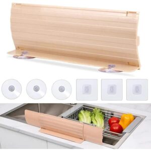 Adjustable sink splash guard with suction cups extended behind kitchen tap