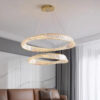 2-ring gold LED crystal chandelier illuminating a modern living room