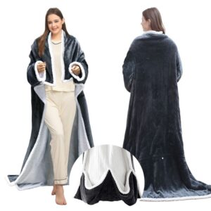 Person wearing a grey wearable electric heated blanket with sleeves on a couch