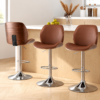 Set of 3 modern brown faux leather and walnut wood bar stools with chrome adjustable bases for kitchen island.
