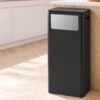 Sleek black plastic kitchen trash can with stainless steel accent panel, rectangular shape, for modern kitchen waste dis