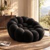 Black bubble-shaped modular armchair, upholstered in textured fabric, for modern living room seating.