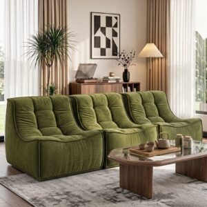 Green velvet modular sofa with tufted cushions, perfect for a modern living room.