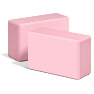 Two rectangular light pink foam yoga blocks with beveled edges for yoga, Pilates, and fitness support.