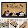 Welcome dog-themed doormat, brown with black border, featuring three dog faces and "Welcome to Our Home" text.