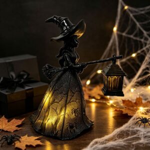Black resin witch figurine with glowing lantern and spider/tree skirt, for Halloween decor.