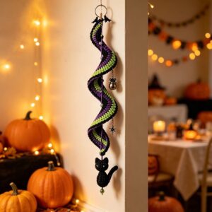 Crochet Halloween spiral decoration: black, purple, lime green yarn, with black cat, witch hat, cauldron, star charms.