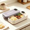 Thermal electric lunch box, light gray plastic lid, beige base, stainless steel interior, for heating meals.
