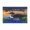 Welcome to the Lake" doormat, black loon with chick on blue water, orange sky, green reeds, outdoor decor.