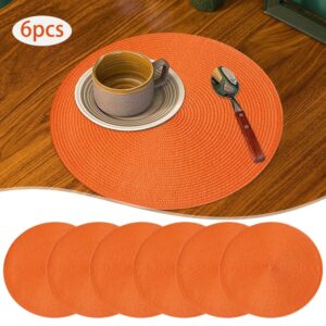 6pcs round woven placemats, orange braided polypropylene, heat-resistant table mats for dining and kitchen decor.