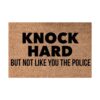 Brown coir doormat with "KNOCK HARD BUT NOT LIKE YOU THE POLICE" in black text, for home entryways.