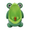Green plastic frog-shaped urinal for boys, with large eyes and an orange spinning target, for potty training.