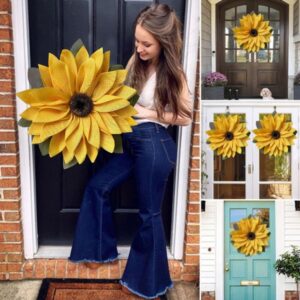 Yellow burlap sunflower wreath with green leaves, brown center, for front door or wall decor.