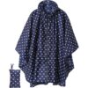 Navy blue polka dot waterproof rain poncho with hood and zipper, made of polyester, for outdoor use.