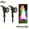 2 black plastic solar-powered RGB LED spotlights with ground stakes, for outdoor garden and landscape lighting.