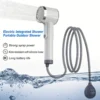White plastic portable electric outdoor shower with grey silicone hose, strong spray, for camping/travel.