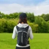 LUVISABER black & grey nylon hiking backpack with reflective strips, worn by woman outdoors.