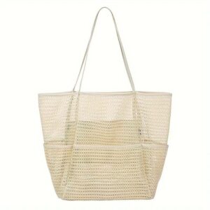Cream mesh beach tote bag with multiple exterior pockets, perfect for carrying essentials to the beach or pool.