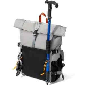 Gray Roll-Top Hiking Backpack With Black Front Pocket, Orange Handle, And Attached Blue Trekking Pole For Outdoor Advent