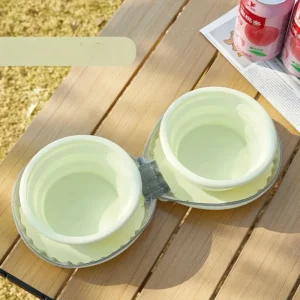Two light green silicone collapsible pet bowls for travel, camping, or outdoor use.