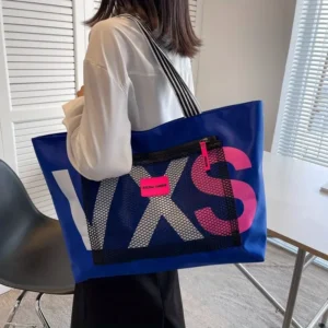 Blue PVC tote bag with large white/pink letters, mesh pocket, and striped strap, for casual use.