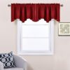 Solid red polyester scalloped valance curtain on a bronze rod, for kitchen or living room window decor.