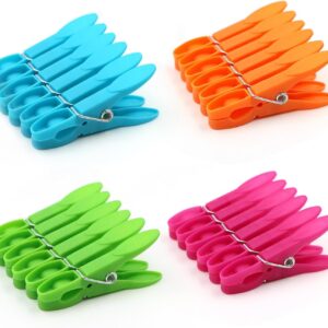 Colorful plastic clothes pins with metal springs in blue, orange, green, and pink for laundry drying.