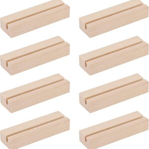 8 light brown rectangular wooden card holders with a narrow slot on top, for displaying photos or place cards.