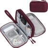 Burgundy fabric electronics organizer pouch with mesh pockets, wrist strap, and zipper closure for travel.
