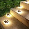 White plastic paw print solar garden lights for outdoor path or stair lighting.