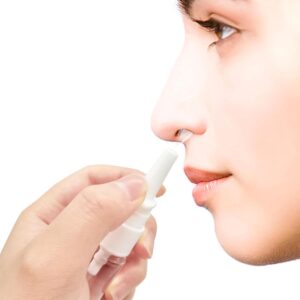 White Plastic Nasal Spray Bottle, Clear Liquid, Being Used By A Person For Sinus Relief.