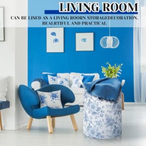 White fabric storage basket with blue floral pattern, handles, and blue blanket, for living room storage.