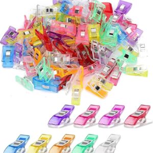 Assorted colorful plastic sewing clips with flat backs, ideal for quilting, crafting, and holding fabric.