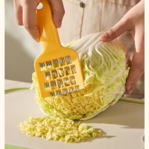 Cute Vegetable Grater &Amp; Shredder — Yellow – Sumo Deals Yellow Plastic Cabbage Shredder With Stainless Steel Blades, Grating Napa Cabbage On A Cutting Board.