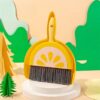 Yellow plastic mini dustpan and brush set with lemon design, gray bristles for desktop cleaning.