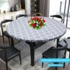 Round elastic-edged vinyl fitted tablecloth, gray with white quatrefoil pattern, for dining table protection.