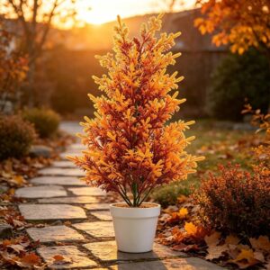 Artificial autumn foliage plant in white pot, vibrant orange and yellow, for outdoor fall decor.