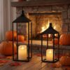 Black metal open-frame decorative lanterns with LED pillar candles, for indoor/outdoor fall decor.