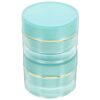 Stackable plastic travel containers, 3-tier, clear with teal lids and gold bands for cosmetics/creams.