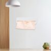 Wall-mounted white plastic trash bag dispenser with peach-colored bags for kitchen or bathroom use.