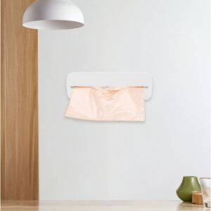 Wall-mounted white plastic trash bag dispenser with peach-colored bags for kitchen or bathroom use.