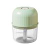 Green plastic electric food chopper with clear bowl and blades for kitchen use.