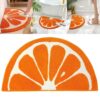 Orange slice half-round bath mat, plush microfiber, vibrant orange and white, for bathroom floor.