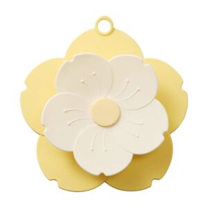 Yellow & white flower-shaped silicone trivet/pot holder with hanging loop, kitchen counter protection.