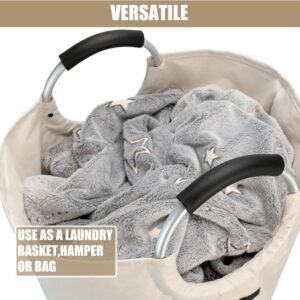 Beige Canvas Laundry Basket With Black Padded Aluminum Handles, Holding A Gray Star-Patterned Fuzzy Blanket.